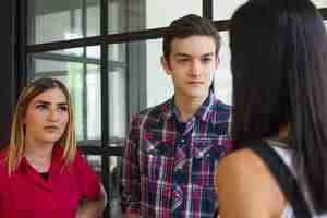 Free photo portrait of young confident student friends talking at break