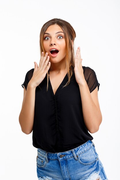 Portrait of young confused  beautiful girl over white background.