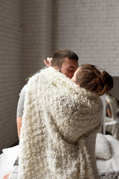 Portrait of young couple kissing