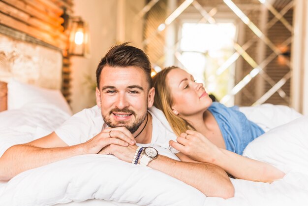 Portrait of a young couple lying on sofa