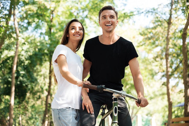 Free photo portrait of a young couple riding on a bicycle together