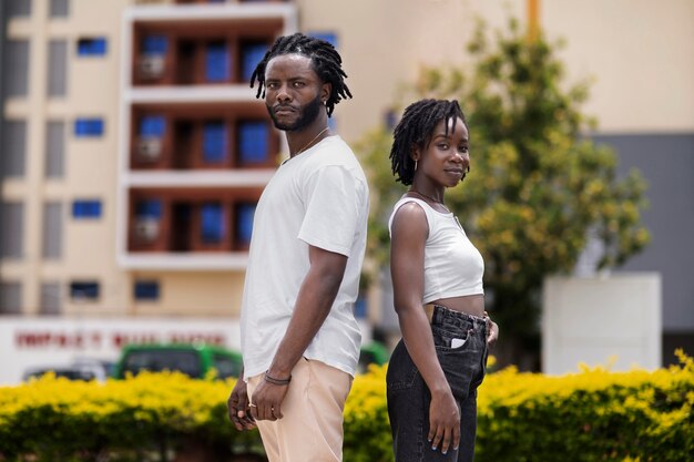 Portrait of young couple with afro dreadlocks outdoors