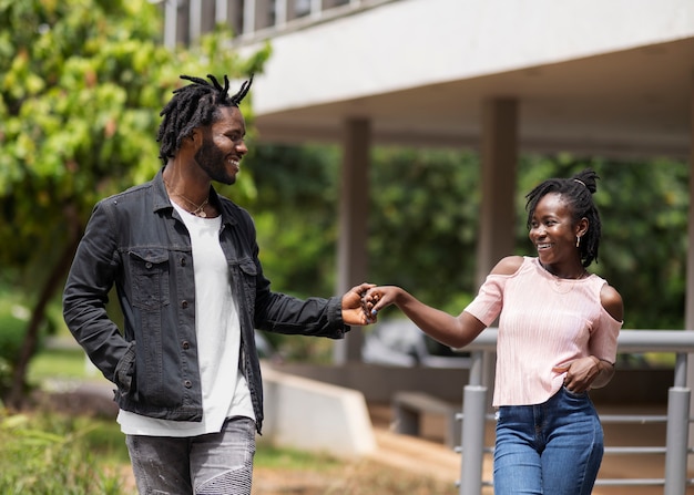 Portrait of young couple with afro dreadlocks outdoors