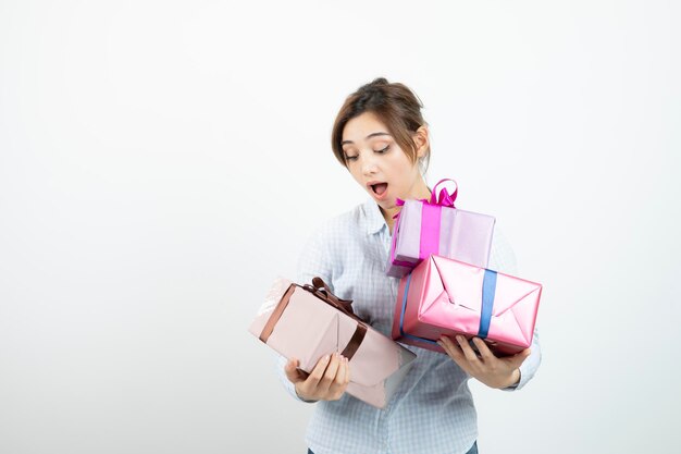 Portrait of a young cute girl holding present box with ribbon. High quality photo