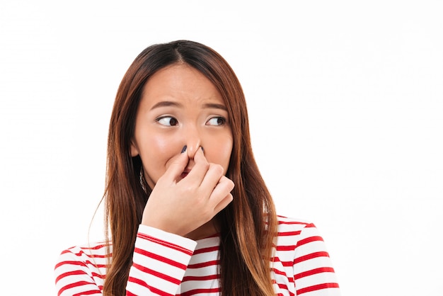 Free photo portrait of a young disgusted asian woman