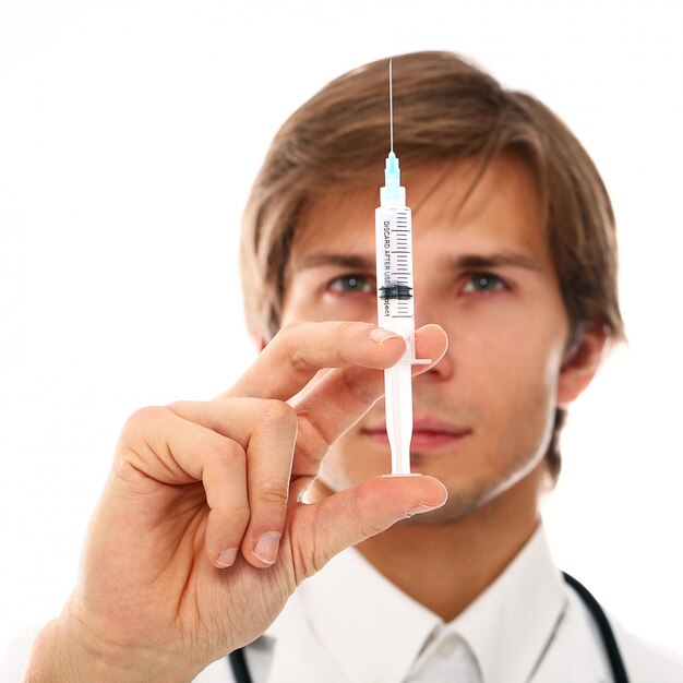 portrait of young doctor man with syringe