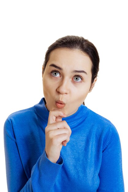 Portrait of young emotive girl in blue sweater isolated over white background