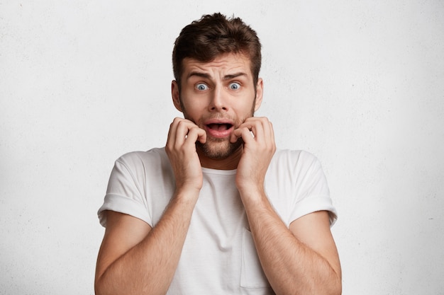 Free Photo | Portrait of young European man being in stupor as sees his