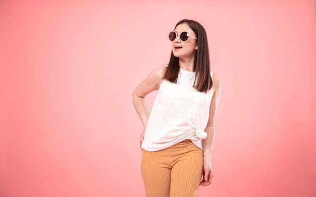 Portrait of young fashion woman in sunglasses smiling