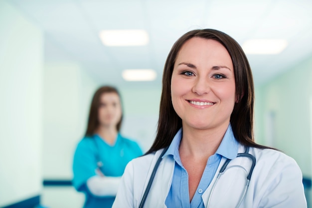 Portrait of young female doctor with intern