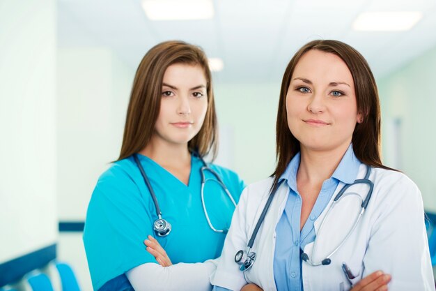 Portrait of young female doctor with intern