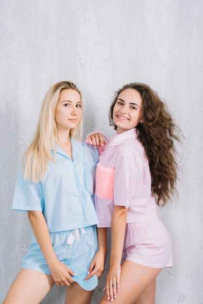 Portrait of young female friends with sleeping eye mask