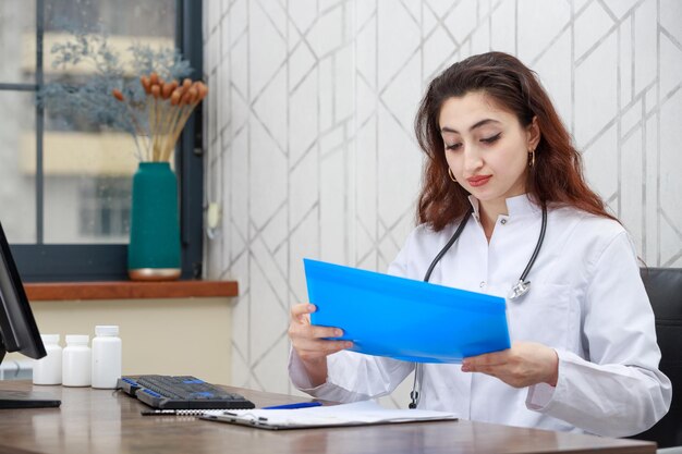 Portrait of young female health care worker checking patient39s analysis High quality photo