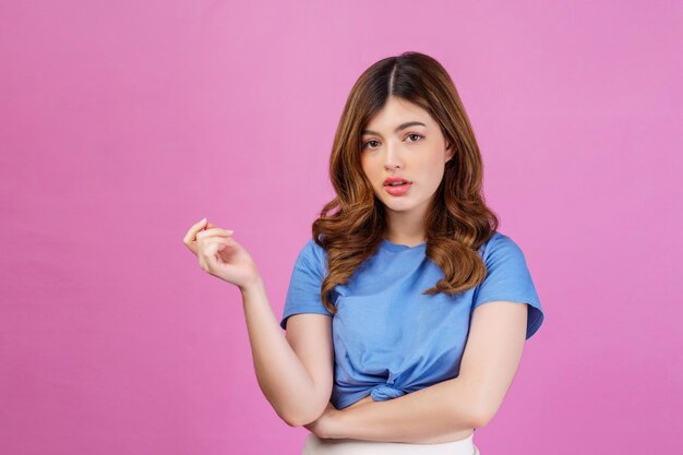 Portrait of young female model with perfect skin posing in fashion isolated over pink background