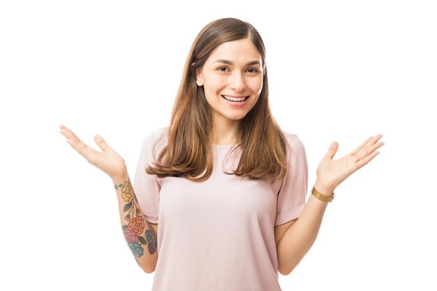 Portrait of young female presenting product over white background