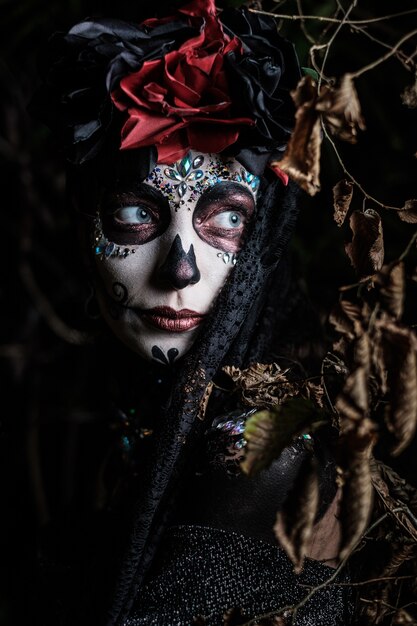 Portrait of a young female in the style of Mexican holiday Day of the Dead