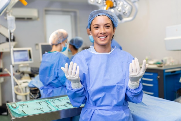 Portrait of young female surgeon doctor surrounded by her team Group of surgeon in operation theatre