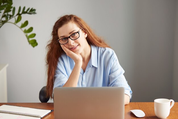 Portrait of young female writer wearing glasses