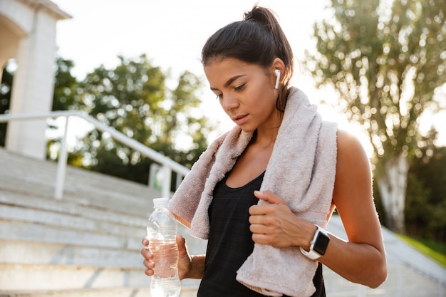 Portrait of a young fitness woman with towel