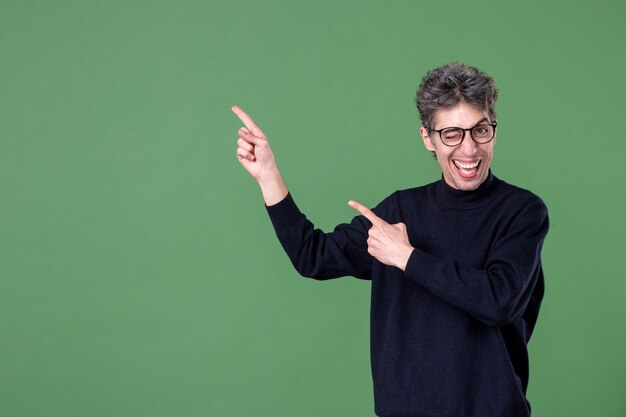 Portrait of young genius man dressed casually in studio shot on green wall