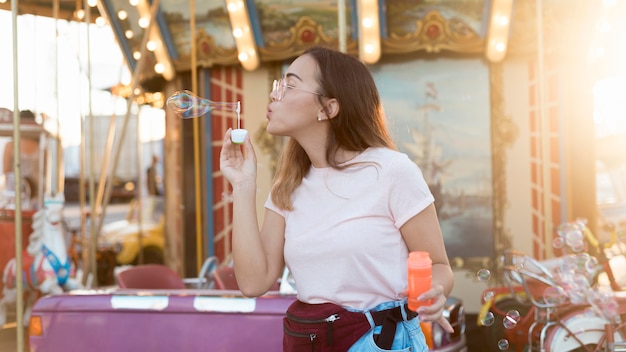 Portrait of young girl blowing bubbles