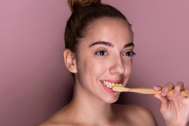 Portrait of young girl brushing her teeth