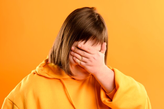 Portrait of young girl covering eyes