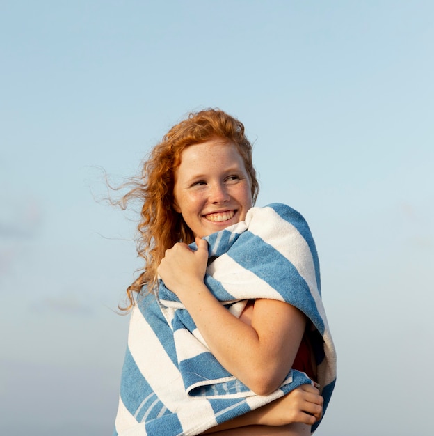 Free photo portrait of young girl enjoying time at the beach