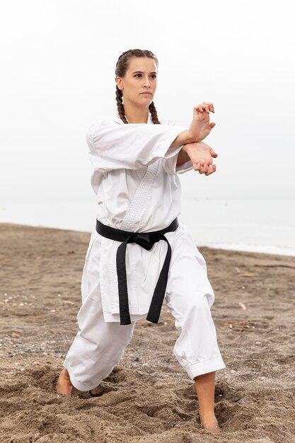 Portrait of young girl exercising karate