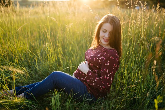 portrait of young girl on grass and trees park landscape