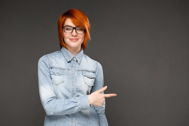 Portrait of young girl over grey background Copy space