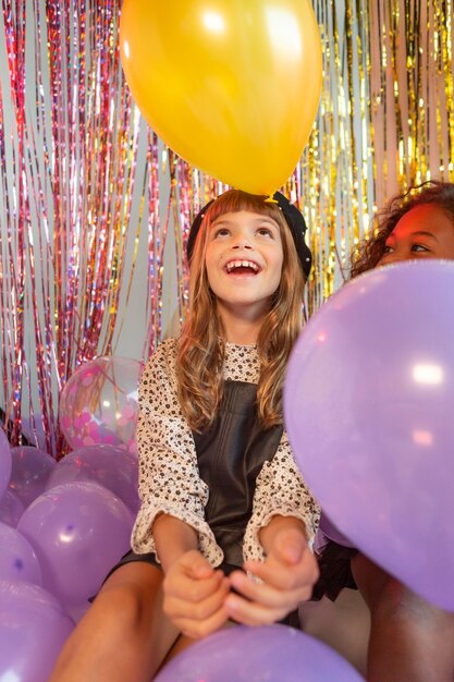 Portrait young girl at party with balloons