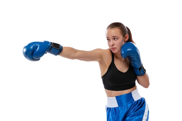 Portrait of young girl professional boxer training isolated over white studio background