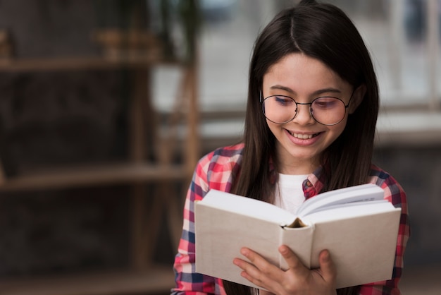 Portrait of young girl reading a book