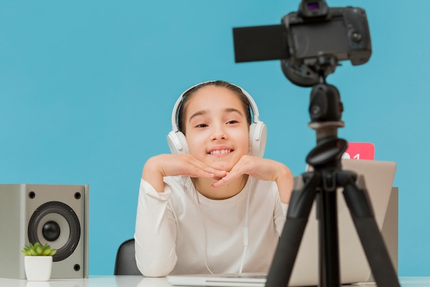 Free photo portrait of young girl recording herself