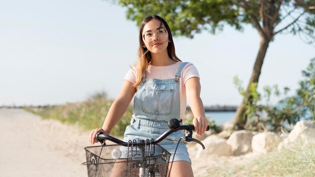 Free photo portrait of young girl riding bike outdoors