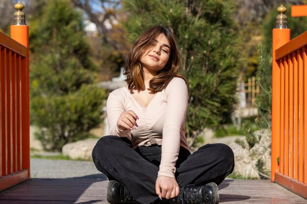 Portrait of young girl sitting on the ground High quality photo