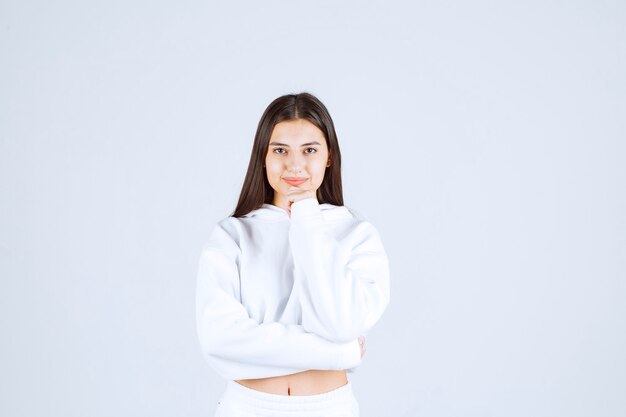 Portrait of a young girl standing and looking at camera.