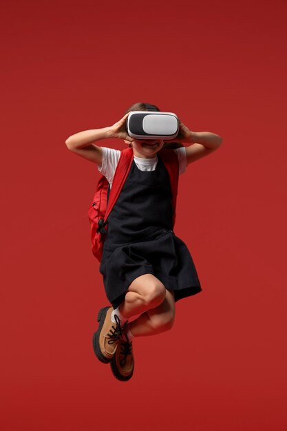 Portrait of young girl student in school uniform and vr glasses