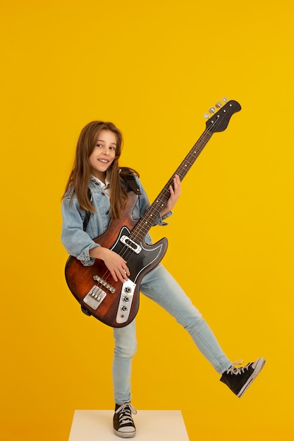 Portrait of young girl with guitar