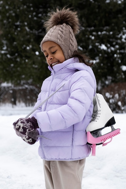 冬の屋外でアイススケート靴と若い女の子の肖像画