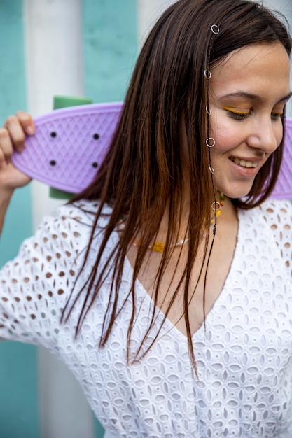 Portrait young girl with skateboard