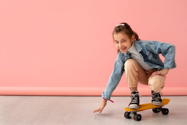 Portrait of young girl with skateboard