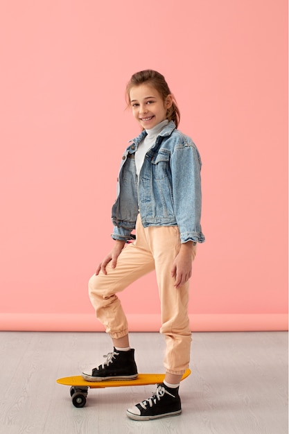 Portrait of young girl with skateboard