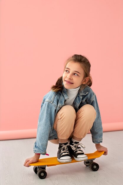 Portrait of young girl with skateboard