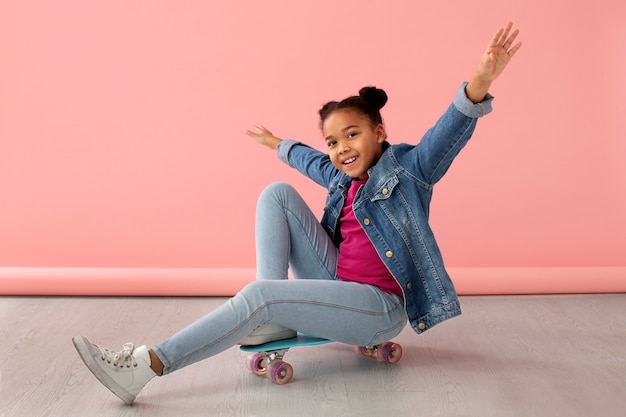 Portrait of young girl with skateboard