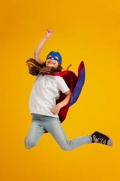 Portrait of young girl with superhero cape