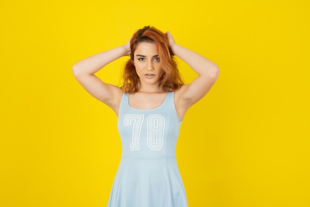 Portrait of young girl. Young redhead giving confident look 