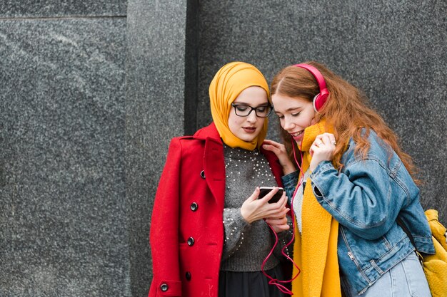 Portrait of young girls listening to music