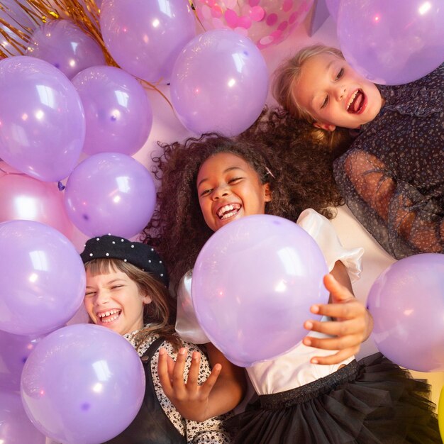 Portrait young girls at party with balloons